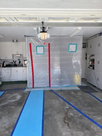 Kitchen sealed with plastic containment and zipper doors over floor protection during a dry-out